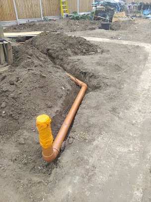 New drainage pipe installation in an excavated trench in Billericay